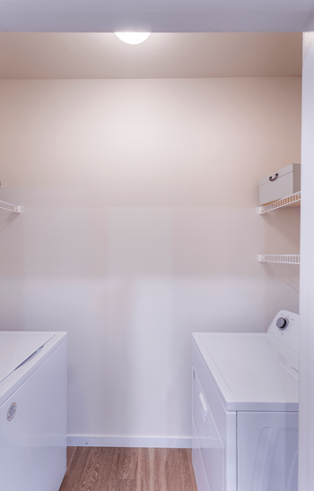 A small laundry room with a washer and dryer.